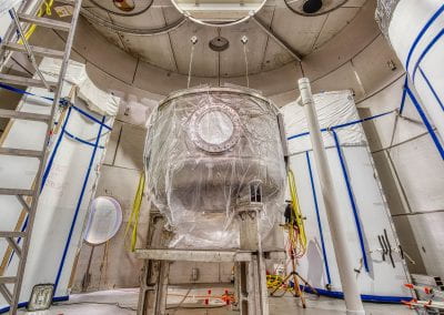 A photo of LZ's outer cryostat standing inside the water tank underground at SURF.